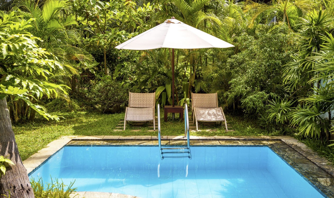 Residential pool with tropical landscaping professionally maintained in Prescott, AZ